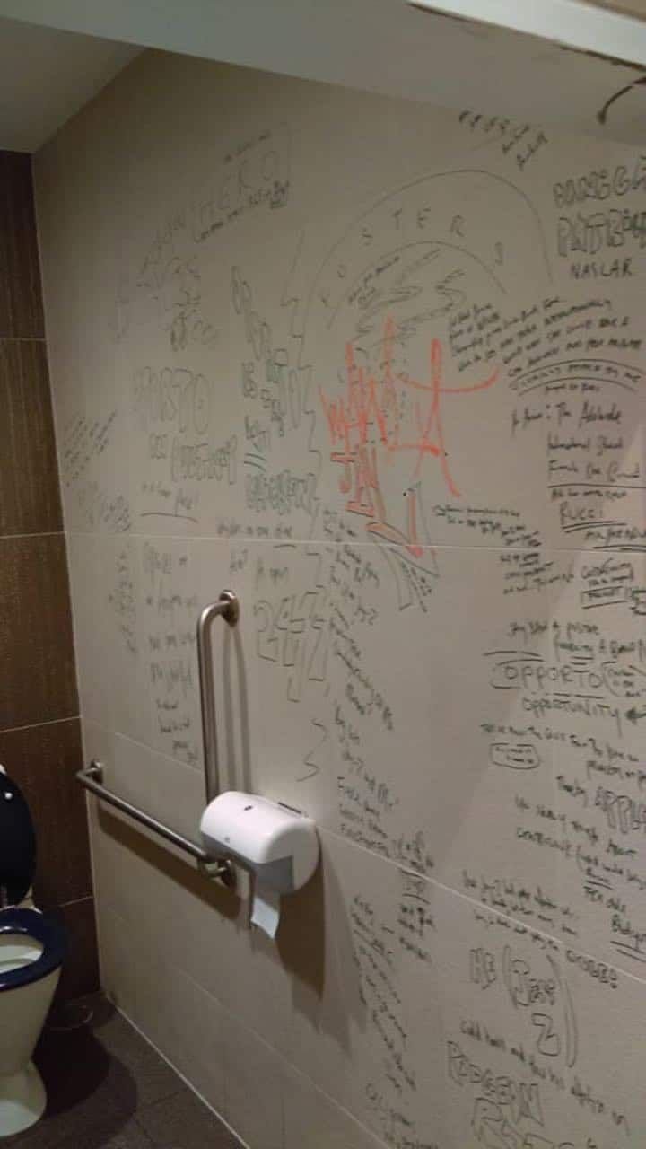 Before shots of the bathroom wall in one of our client's Glenelg restaurant - we used eco-friendly cleaning solution to remove this graffiti