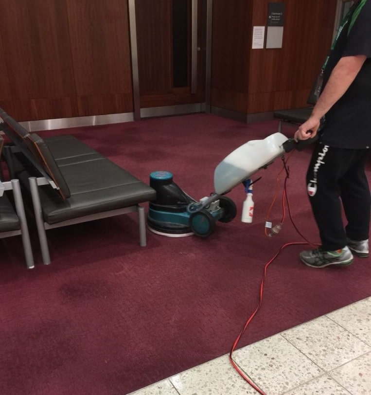 One of our skilled cleaners doing low pressure cleaning in Watpac's Adelaide office